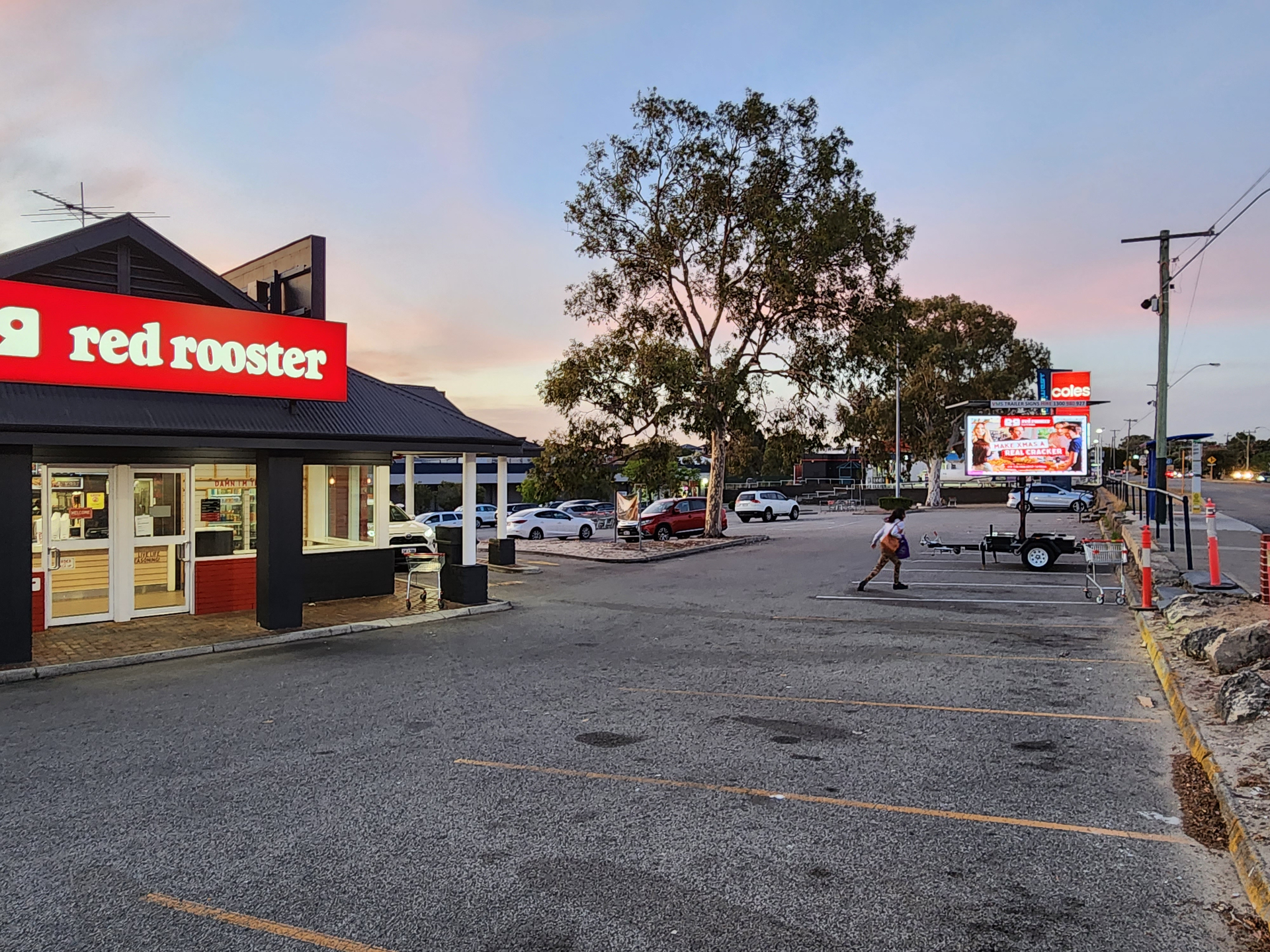Red Rooster storefront at dusk